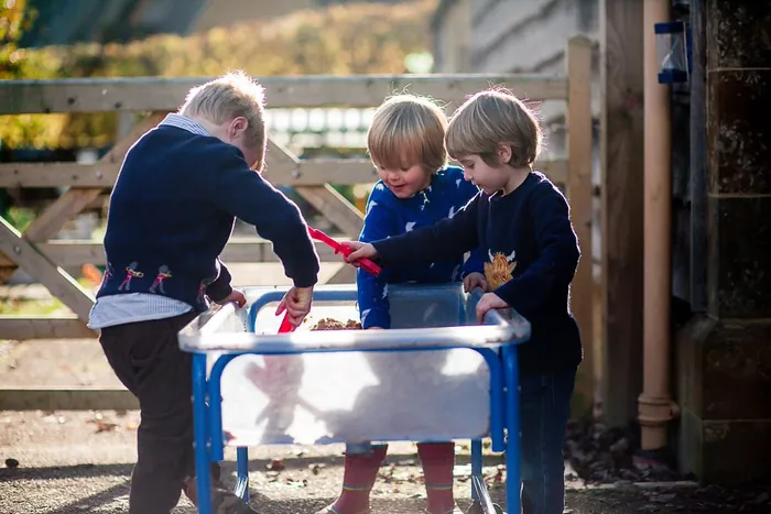 Children playing at the water tray